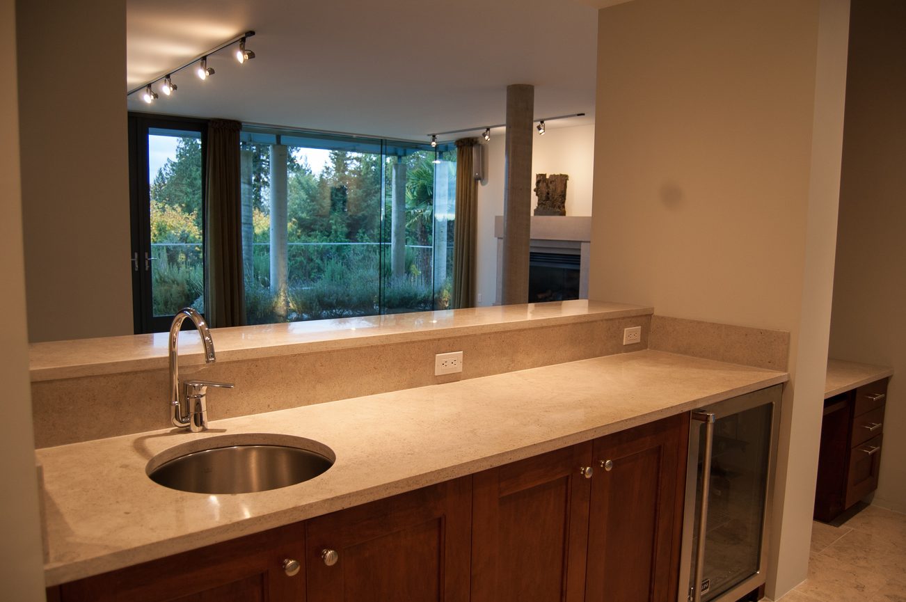Bright kitchen with granite countertops and a city view. - 4454 Regency Place, West Vancouver