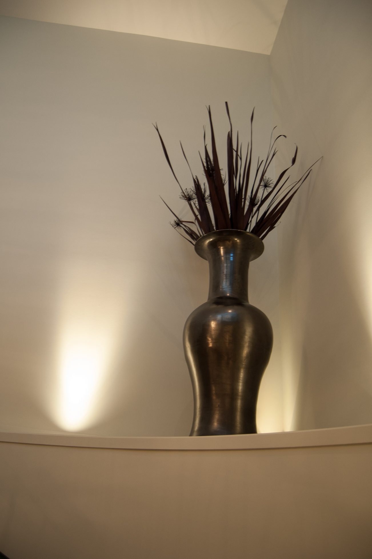 Bright living room with modern vase and dried flowers on a sleek white shelf. - 4454 Regency Place, West Vancouver