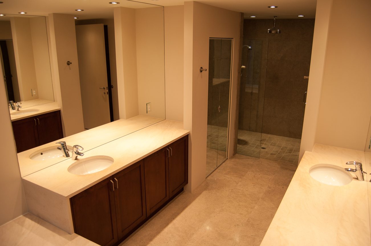 Spacious bathroom with dual sinks, large mirror, and walk-in shower. - 4454 Regency Place, West Vancouver