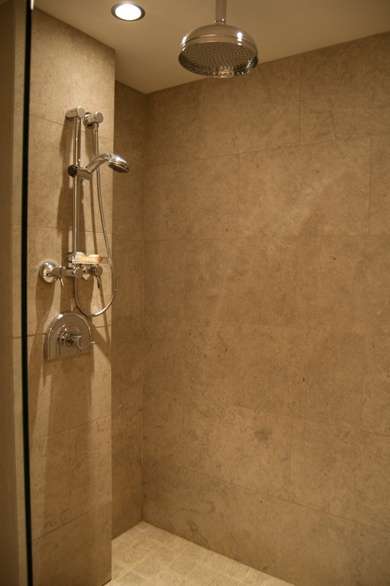 Modern shower with beige tiles and rainfall showerhead. - 4454 Regency Place, West Vancouver