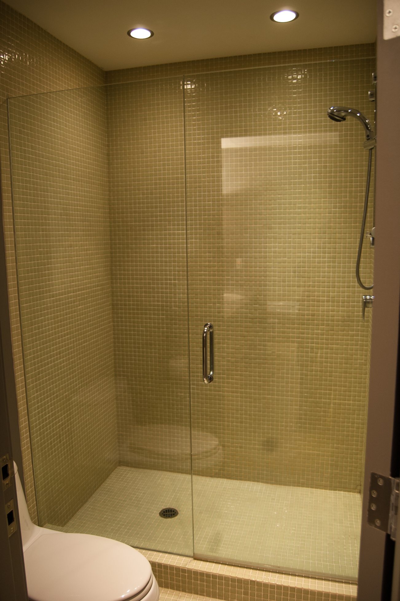 Modern shower with glass enclosure and mosaic tiles. - 4454 Regency Place, West Vancouver