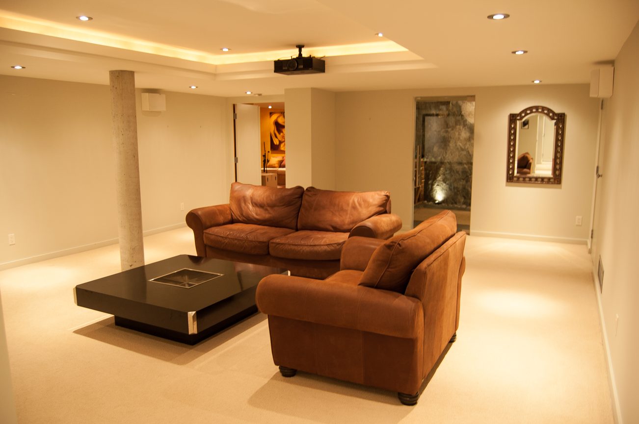 Furnished living room with modern furniture and recessed lighting. - 4454 Regency Place, West Vancouver