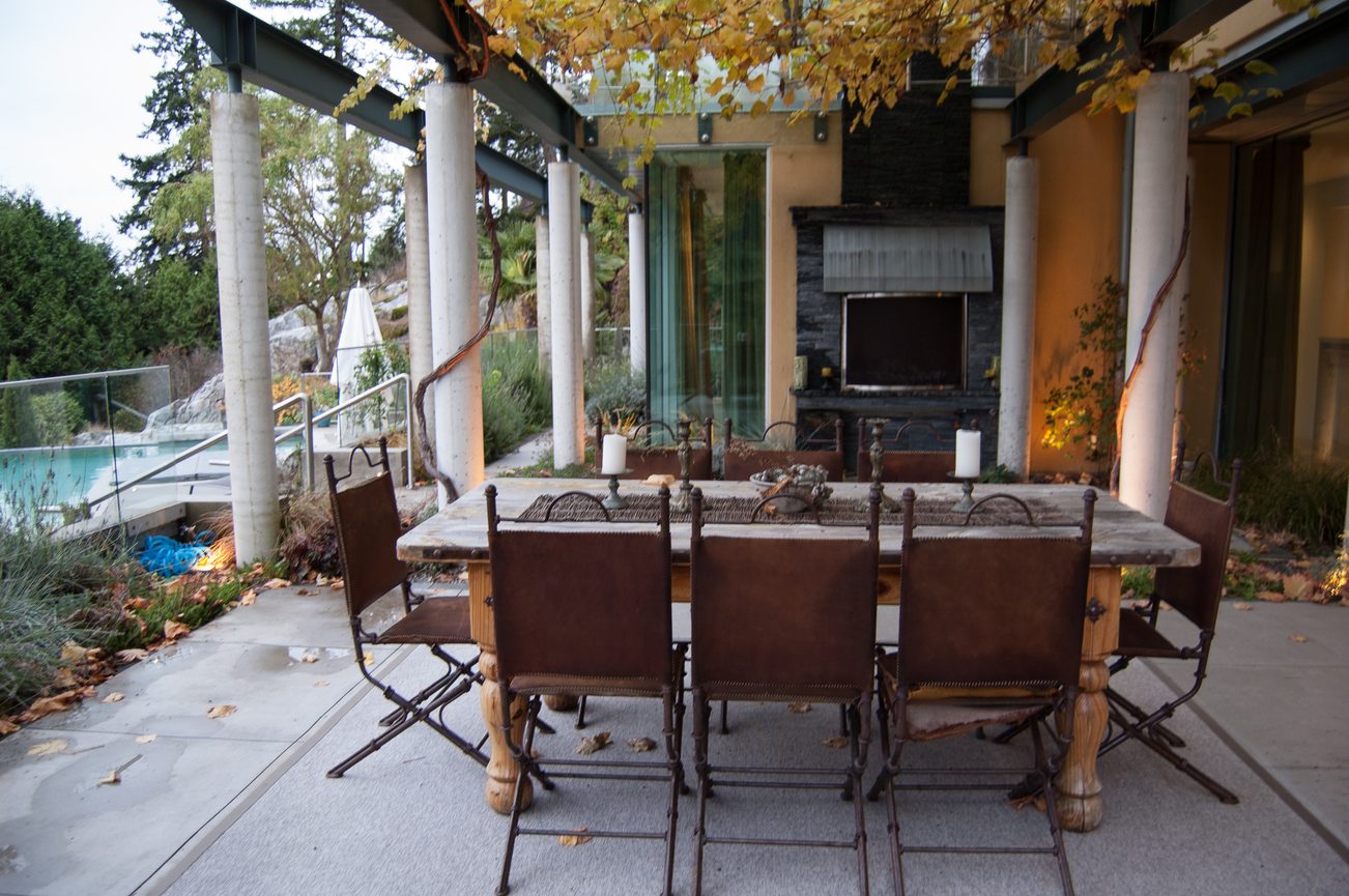 Furnished dining area with outdoor seating and a view of the pool and garden. - 4454 Regency Place, West Vancouver