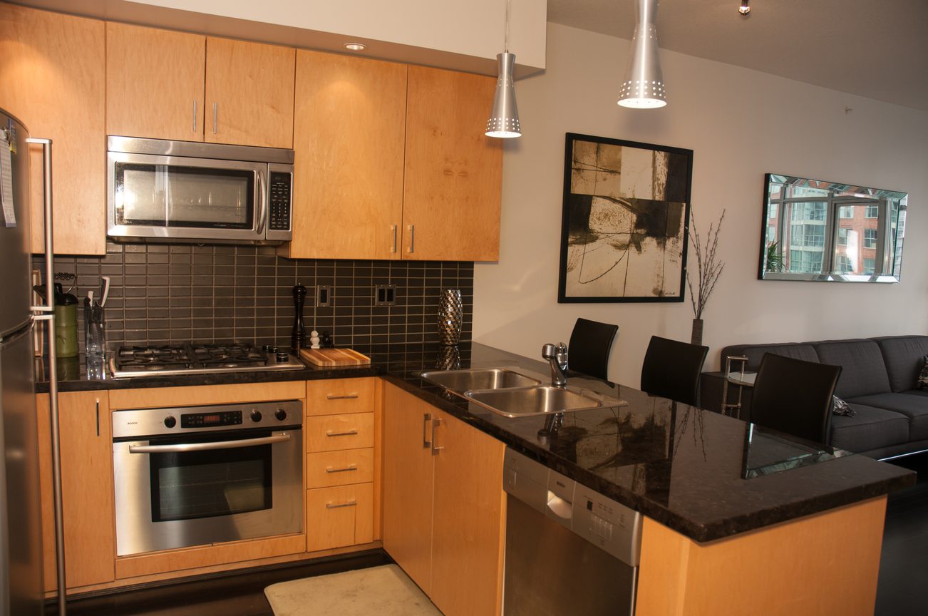 Bright kitchen with granite countertops, modern appliances, and a city view. - 1406-1050 Smithe, Vancouver Downtown