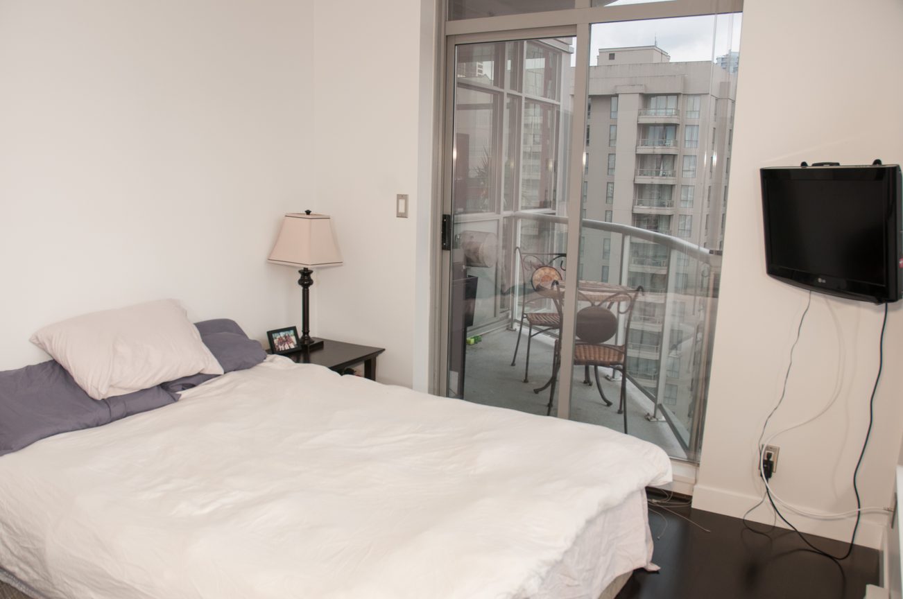 Bright bedroom with city view, furnished, and sliding glass door leading to balcony. - 1406-1050 Smithe, Vancouver Downtown
