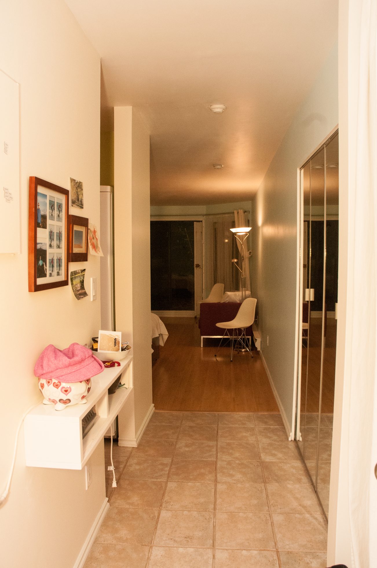 Furnished hallway leading to living area with hardwood floors and modern furniture. - 104 - 575 W 13th Ave, Vancouver West Side