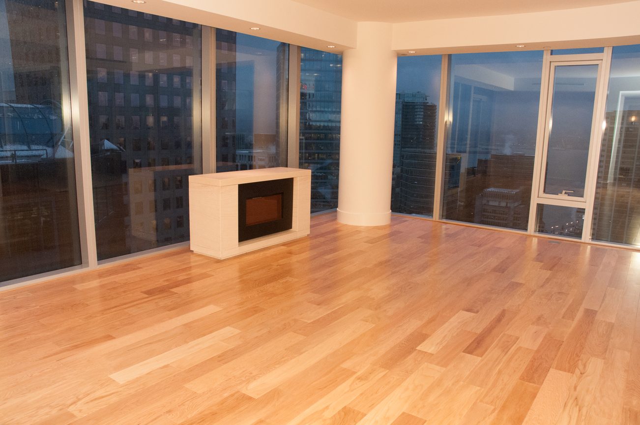 Bright living room with hardwood floors, city view, and modern fireplace. - 3102 - 667 Howe Street, Vancouver Downtown