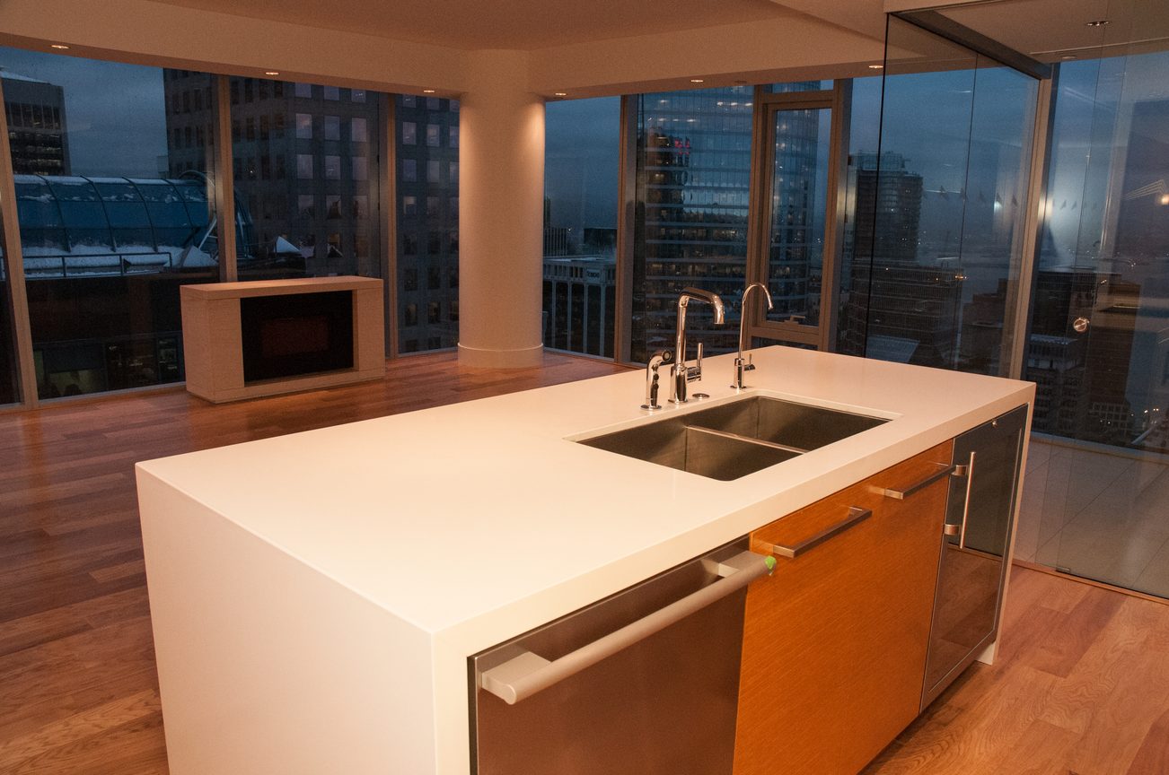Bright kitchen with white countertops, hardwood floors, and a city view. - 3102 - 667 Howe Street, Vancouver Downtown