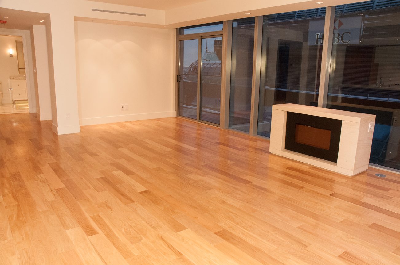 Bright living room with hardwood floors and sliding glass doors, showcasing a city view. - 3102 - 667 Howe Street, Vancouver Downtown