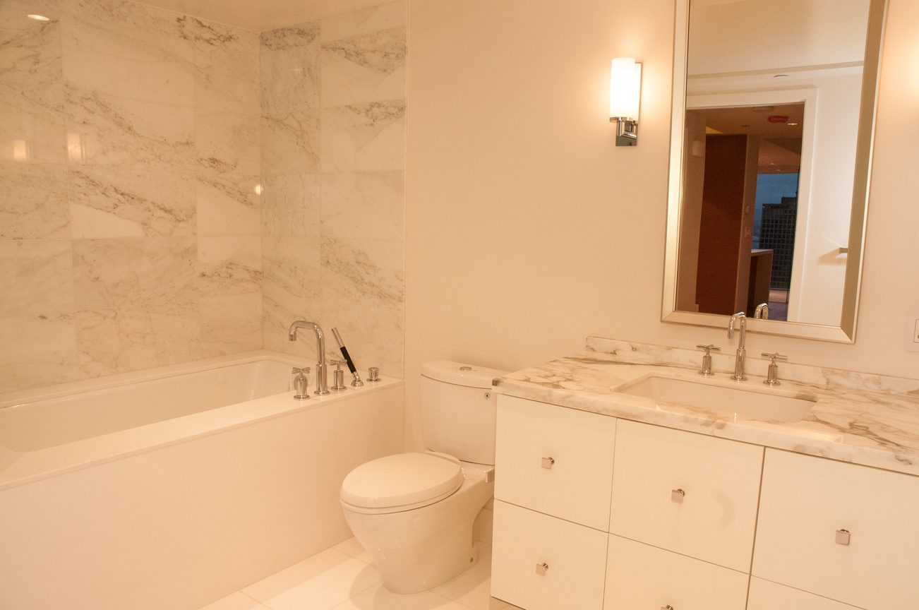 Spacious bathroom with marble countertops and a city view mirror. - 3102 - 667 Howe Street, Vancouver Downtown