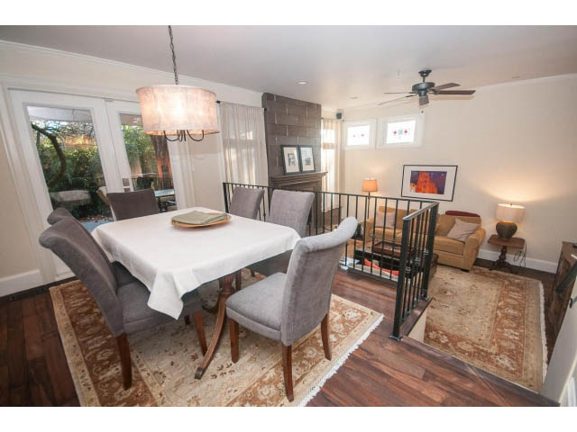 Furnished dining and living area with hardwood floors, a fireplace, and a chandelier. - 14 West 13th Ave, Vancouver East Side