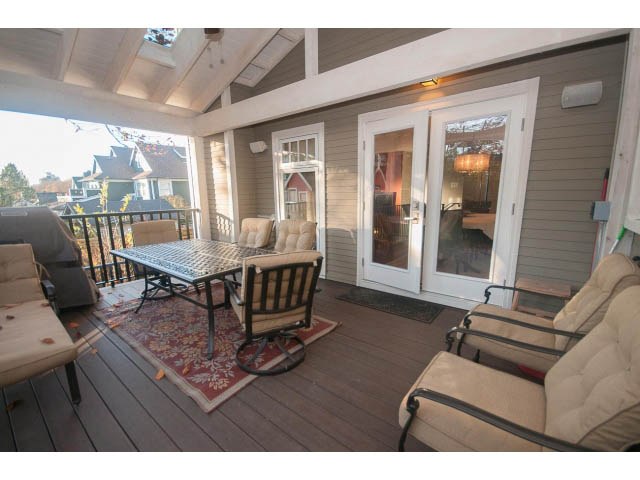 Furnished patio with wooden deck, outdoor furniture, and city view. - 14 West 13th Ave, Vancouver East Side
