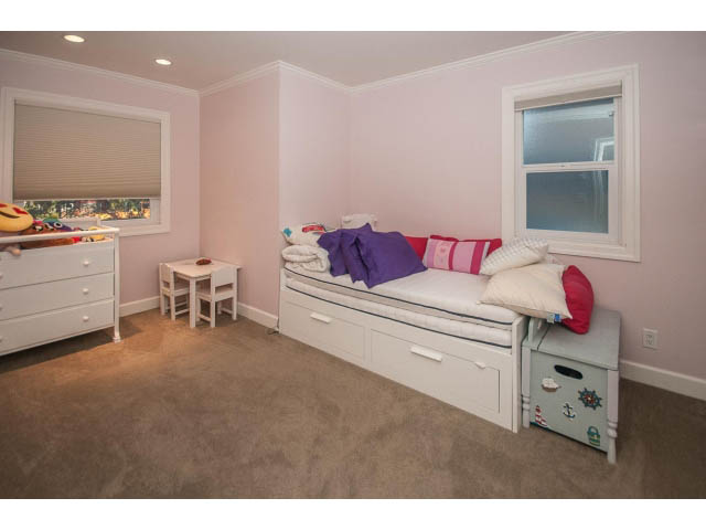Bright bedroom with twin beds, purple bedding, and a small white dresser. - 14 West 13th Ave, Vancouver East Side