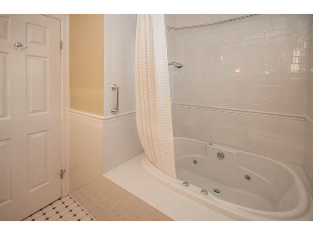 Bathroom with white tile, bathtub, and shower. - 14 West 13th Ave, Vancouver East Side