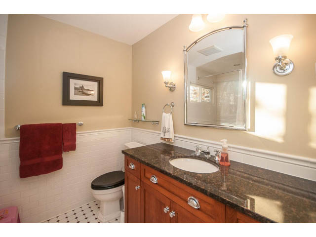 Furnished bathroom with granite countertops and wooden cabinets. - 14 West 13th Ave, Vancouver East Side