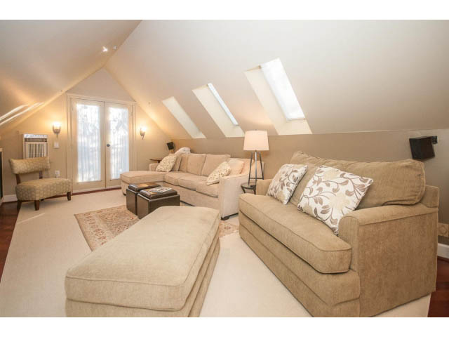Spacious attic living room with vaulted ceilings and large windows. - 14 West 13th Ave, Vancouver East Side