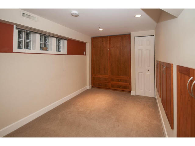 Spacious basement with wooden cabinets and carpeted flooring. - 14 West 13th Ave, Vancouver East Side