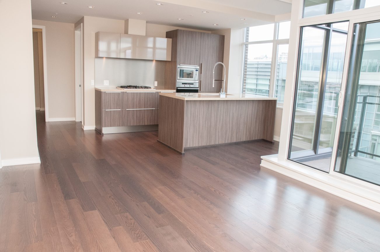 Bright kitchen with hardwood floors, city view, and modern cabinetry. - 1010-181 West 1st Avenue, Vancouver West Side