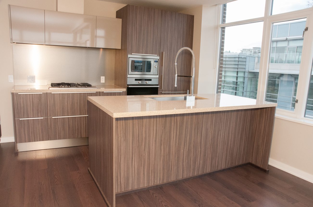 Bright kitchen with modern island, hardwood floors, and city view. - 1010-181 West 1st Avenue, Vancouver West Side