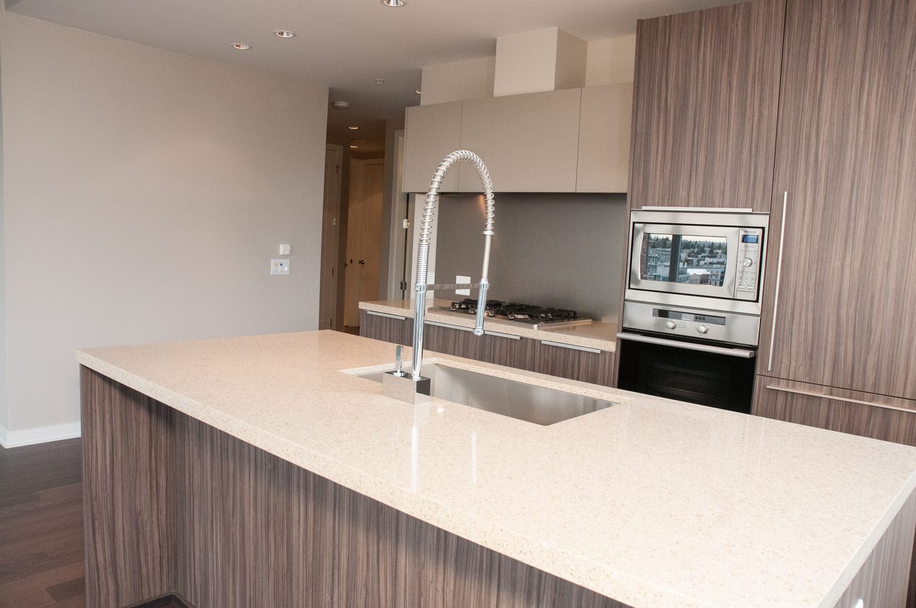 Bright kitchen with modern island, granite countertops, and stainless steel appliances. - 1010-181 West 1st Avenue, Vancouver West Side