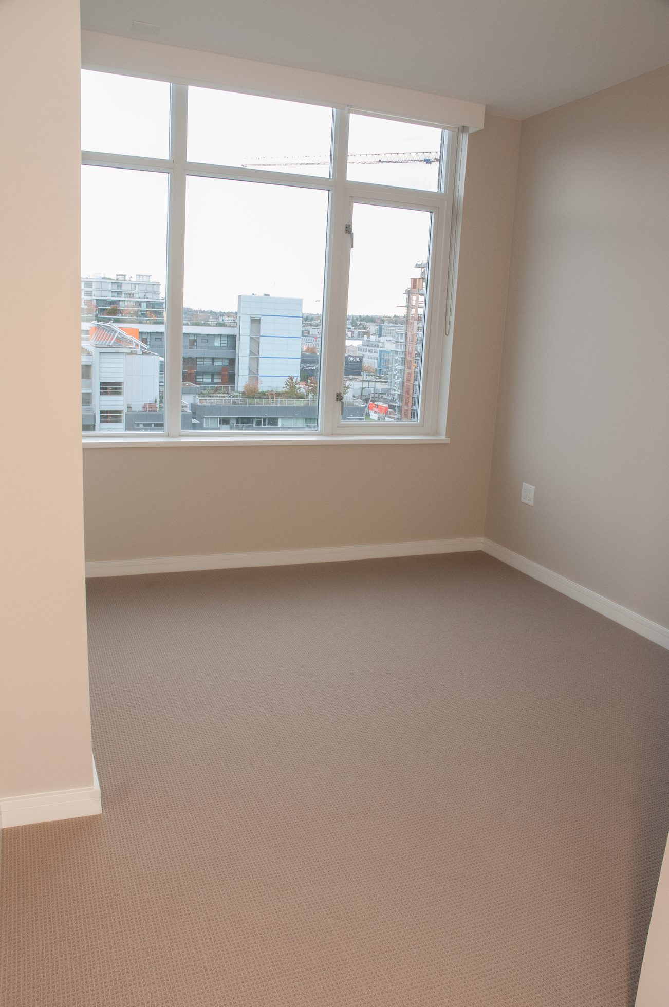 Bright den with large window, city view, and neutral carpeting. - 1010-181 West 1st Avenue, Vancouver West Side