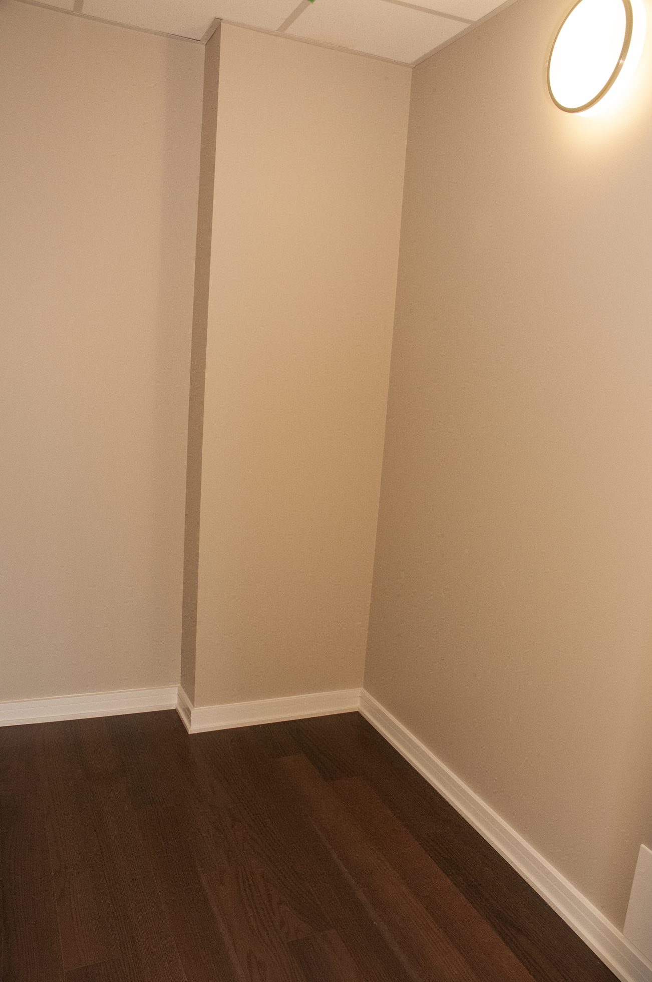 Bright hallway with dark hardwood floors and neutral walls. - 1010-181 West 1st Avenue, Vancouver West Side