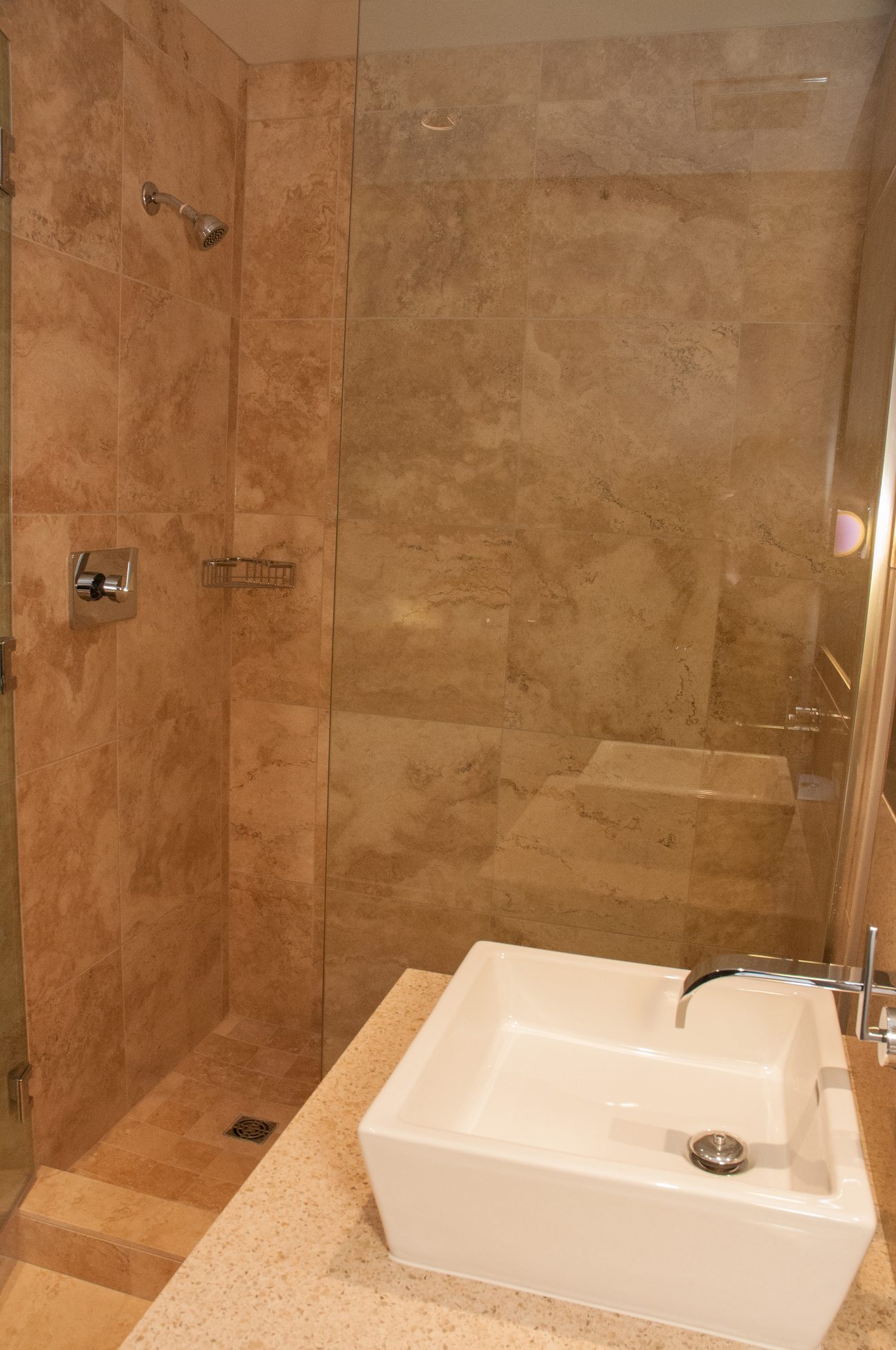 Bathroom with marble tiles, modern sink, and glass shower. - 1010-181 West 1st Avenue, Vancouver West Side