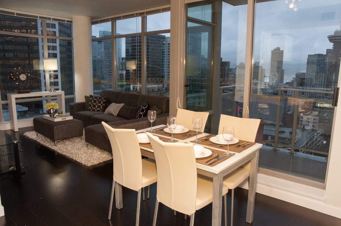 Dining and living area with modern furniture, city view, hardwood floors. - 2306-788 Richards, Vancouver Downtown