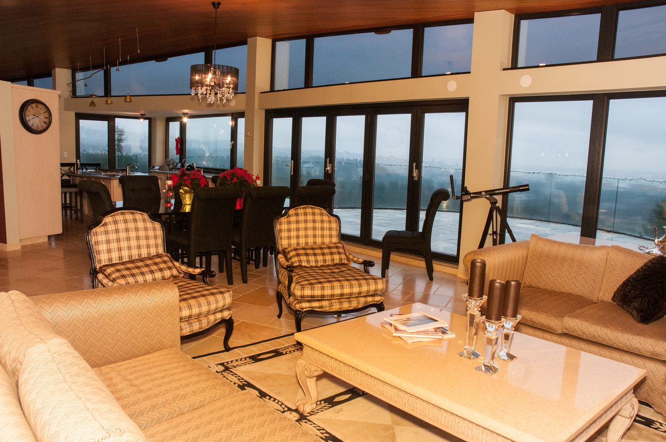 Spacious living room with large windows, city view, and plush furniture. - 829 Younette Drive, West Vancouver