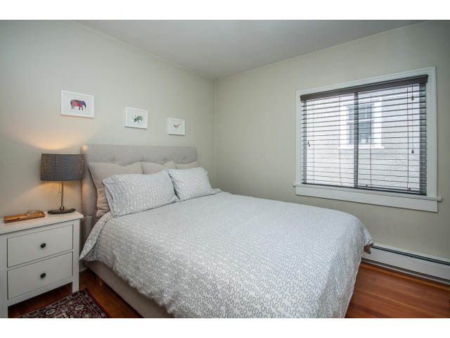 Furnished bedroom with hardwood floors and a window with blinds. - Upper - 4838 Dunbar Street, Vancouver West Side
