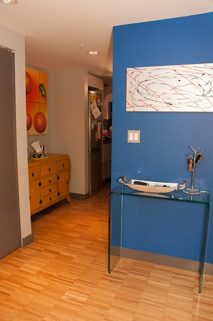 Bright kitchen with wooden floors and colorful artwork, modern decor. - 506-128 West Cordova St, Vancouver Downtown