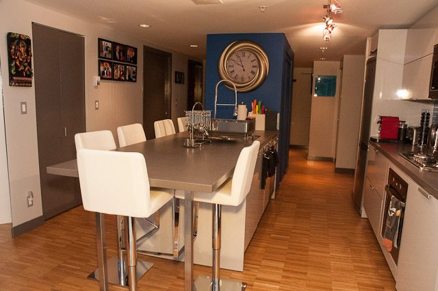 Bright dining area with modern furnishings, hardwood floors, and a large clock on the wall. - 506-128 West Cordova St, Vancouver Downtown