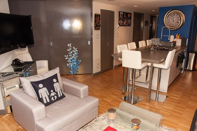 Furnished living room with modern furniture, hardwood floors, and a kitchen area with a dining table. - 506-128 West Cordova St, Vancouver Downtown