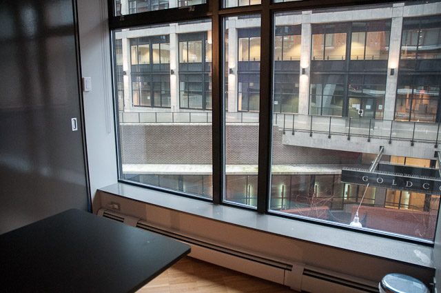 Spacious living room with large windows, city view, and modern furnishings. - 506-128 West Cordova St, Vancouver Downtown