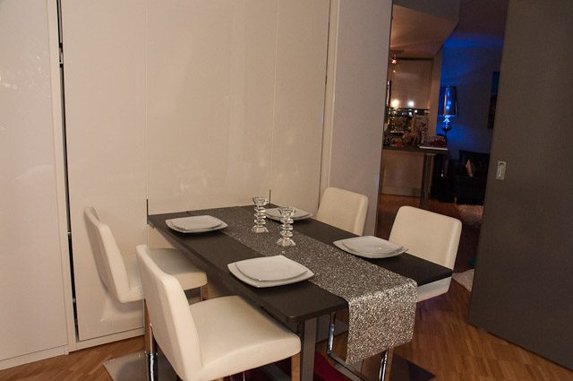 Furnished dining area with modern chairs and a sleek table, hardwood floors visible. - 506-128 West Cordova St, Vancouver Downtown