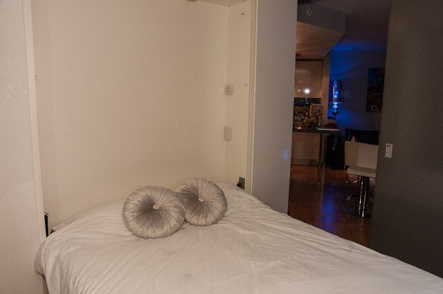 Bright bedroom with white bedding and a cozy ambiance. - 506-128 West Cordova St, Vancouver Downtown