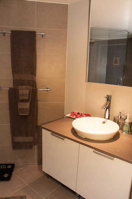 Modern bathroom with sleek countertop and wall-mounted sink. - 506-128 West Cordova St, Vancouver Downtown