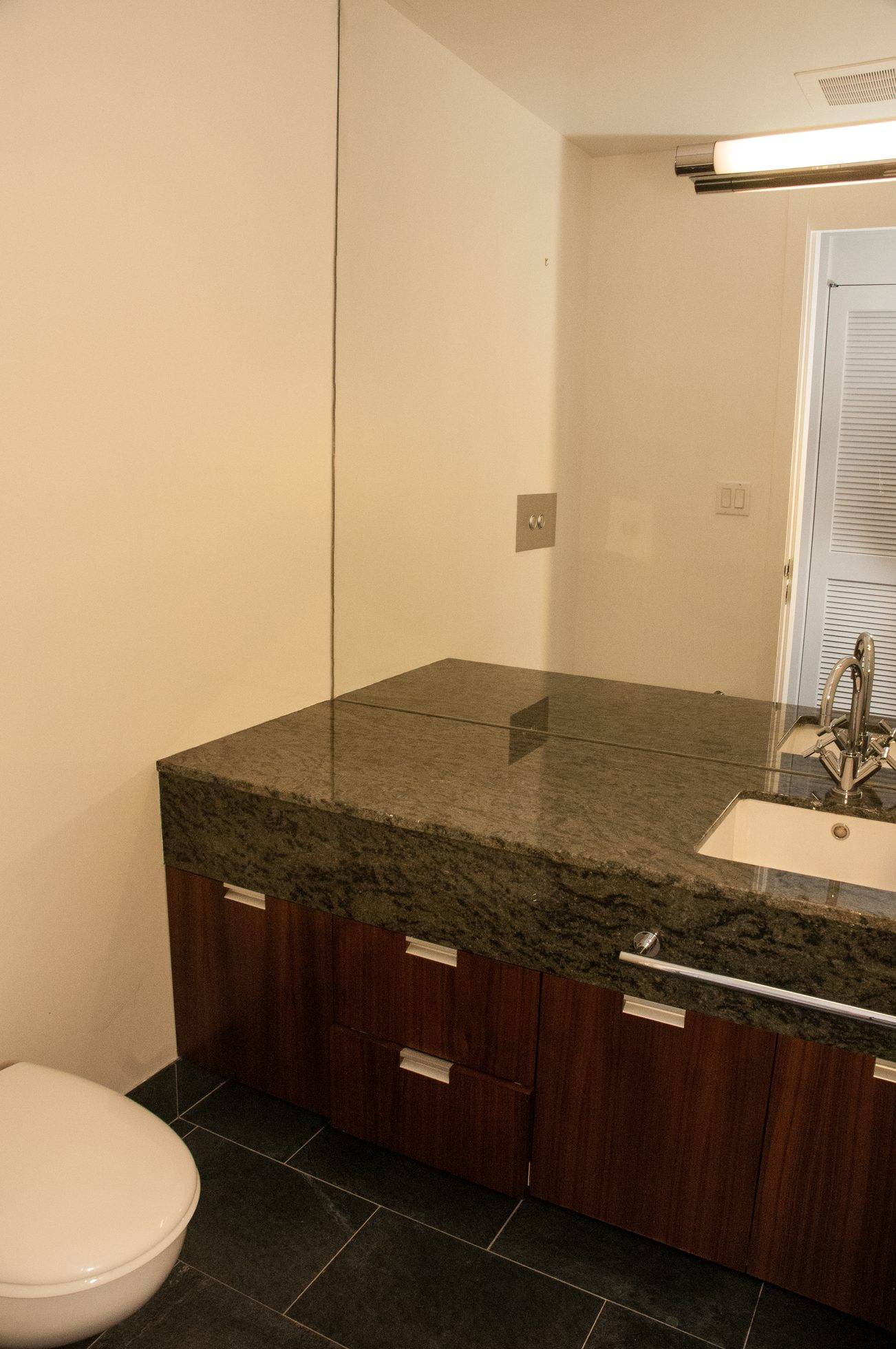 Bathroom with granite countertop and dark wood cabinets. - 3201 - 1077 Cordova Street W, Vancouver Downtown