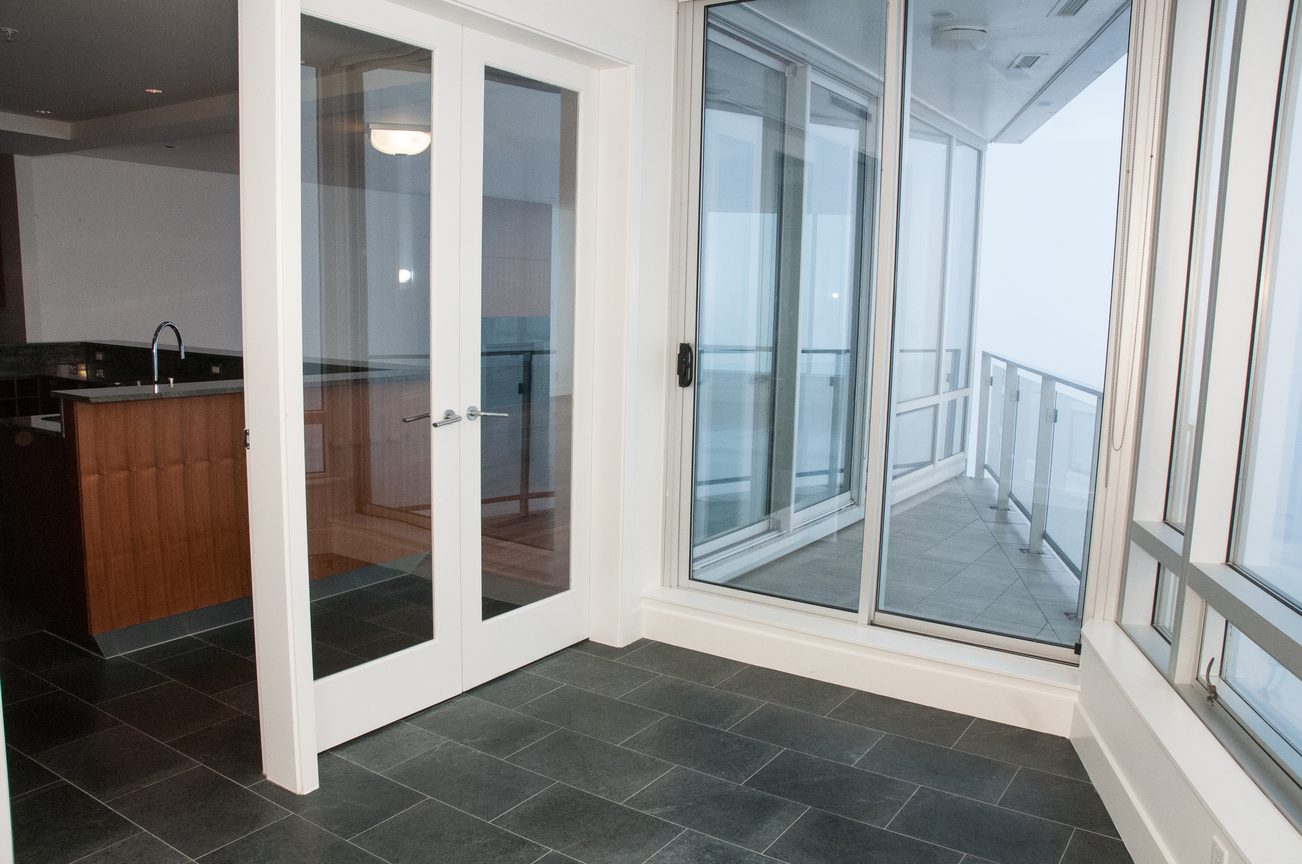 Bright living room with large windows, hardwood floors, and city view. - 3201 - 1077 Cordova Street W, Vancouver Downtown