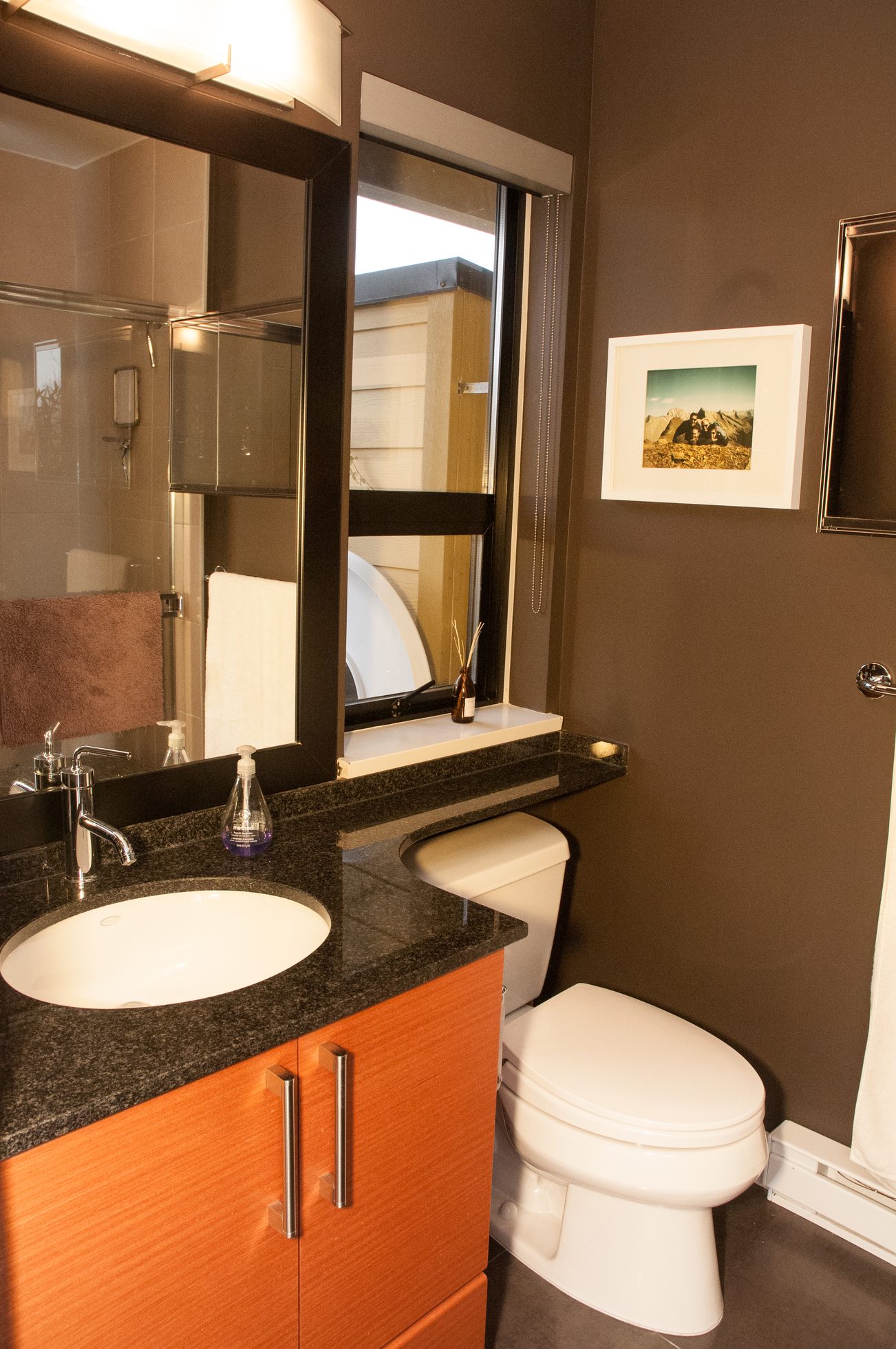 Modern bathroom with black countertop and wooden cabinets. - 125- 1863 Stainsbury Ave, Vancouver West Side