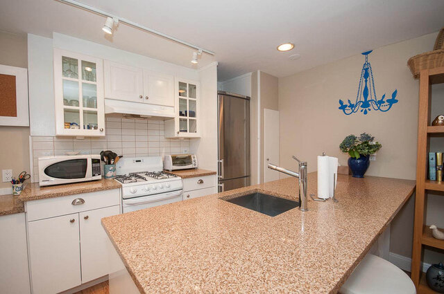Bright kitchen with granite countertops, white cabinets, and a blue chandelier decal. - Address WITHHELD, North Vancouver