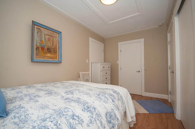 Spacious bedroom with twin beds, blue toiletries, and a white dresser. - Address WITHHELD, North Vancouver