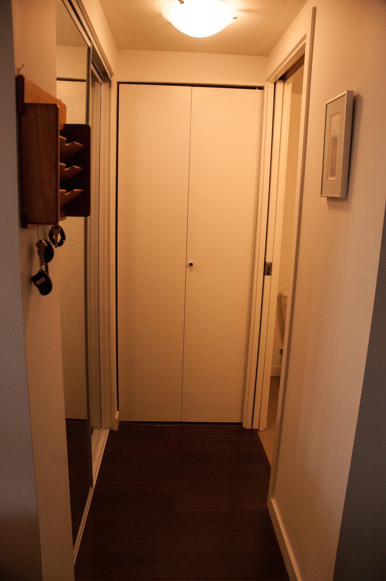 Entryway with coat rack and door leading to another room. - TH4 - 1288 Chesterfield Ave, North Vancouver