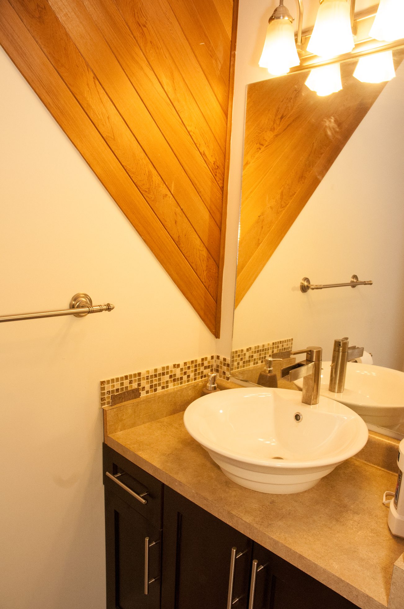 Bathroom with wooden accent wall and modern sink. - 5550 Huckleberry Lane, North Vancouver