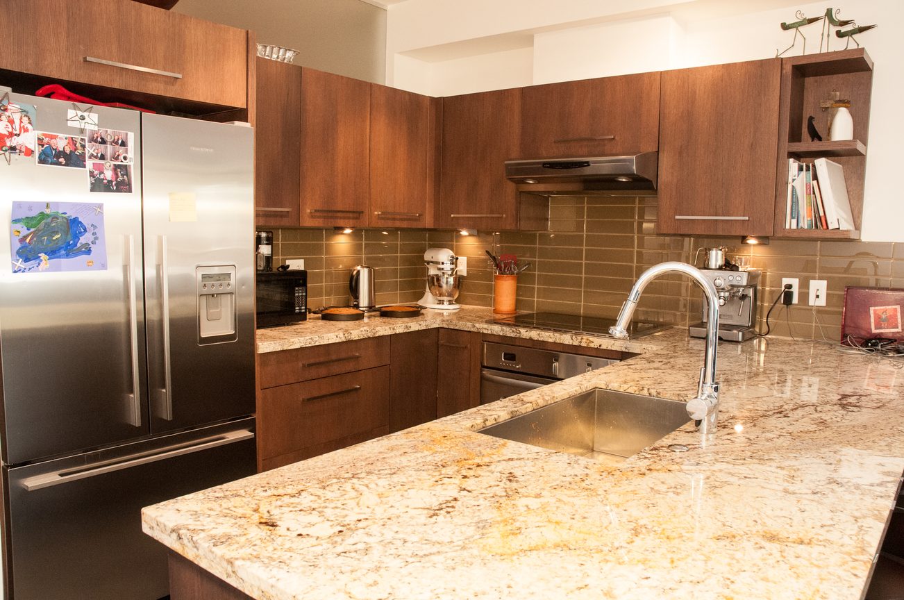 Bright kitchen with granite countertops and stainless steel appliances. - 306-650 Evergreen Place, North Vancouver