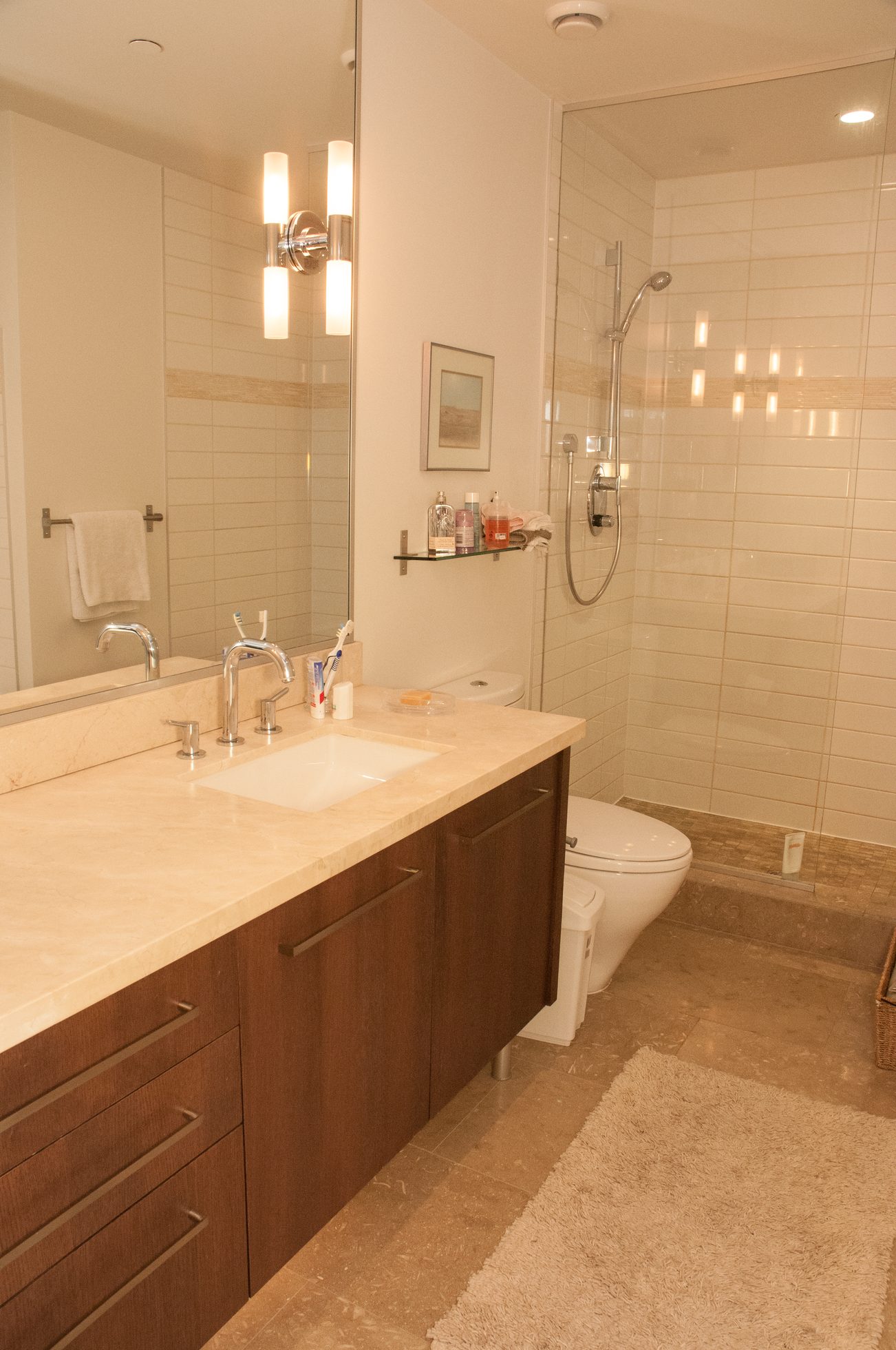 Furnished bathroom with marble countertops and a glass shower. - 306-650 Evergreen Place, North Vancouver