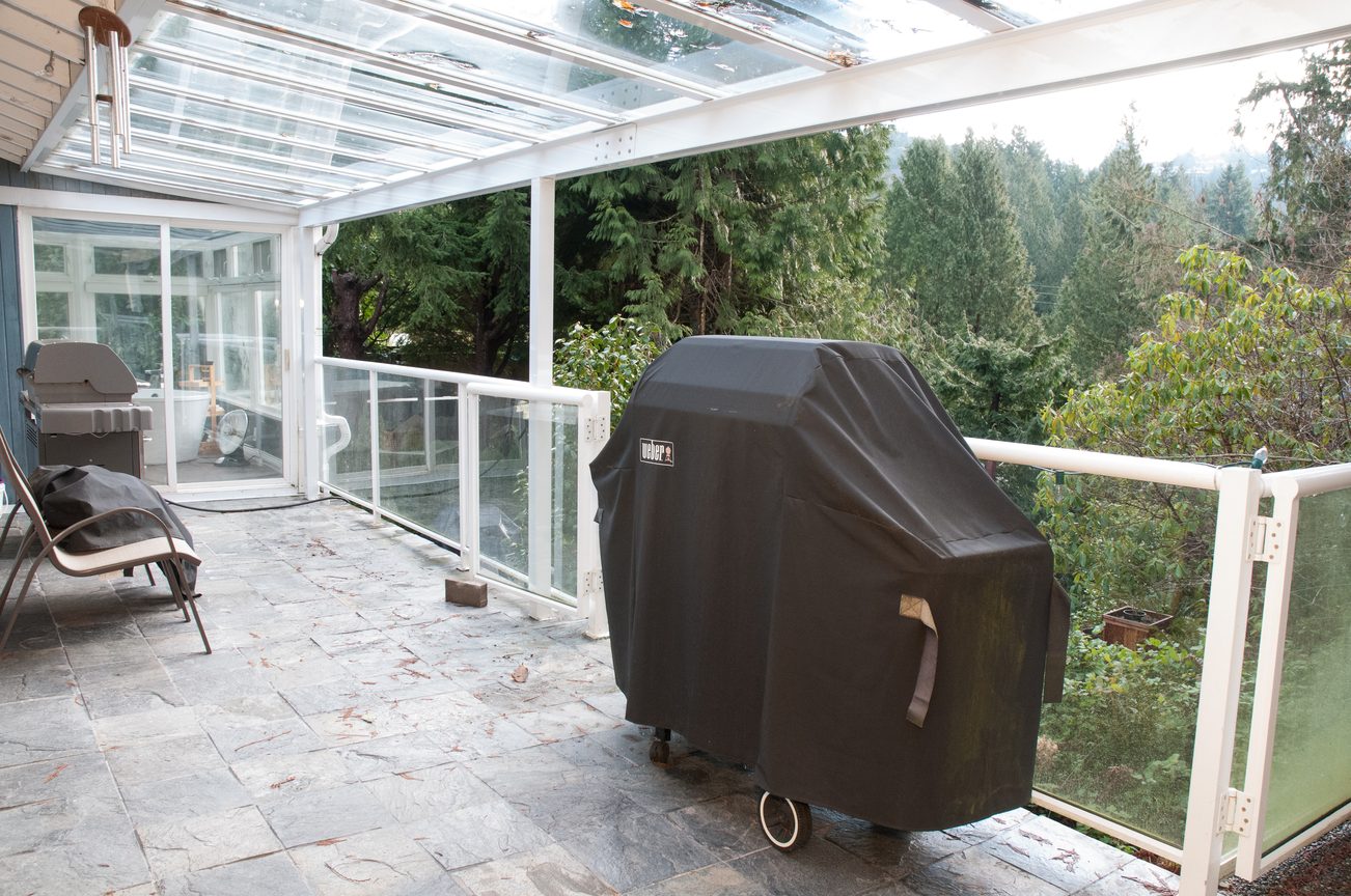 Covered patio with outdoor grill and forest view. - 5646 Westport Rd, West Vancouver