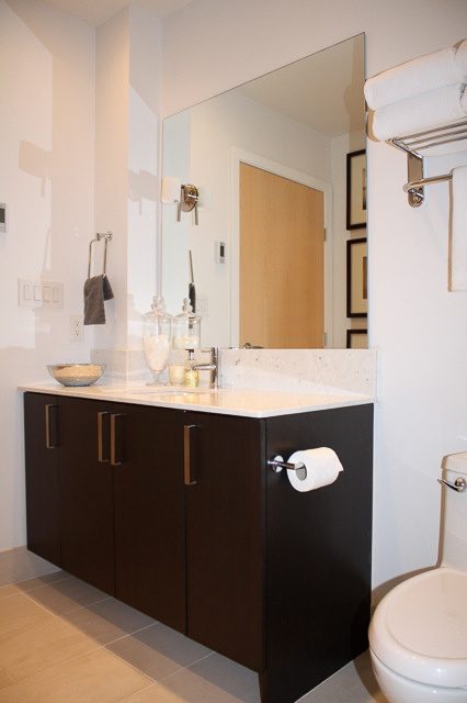 Bright bathroom with dark wood cabinets and white countertops. - 702- 546 Beatty Street, Vancouver Downtown