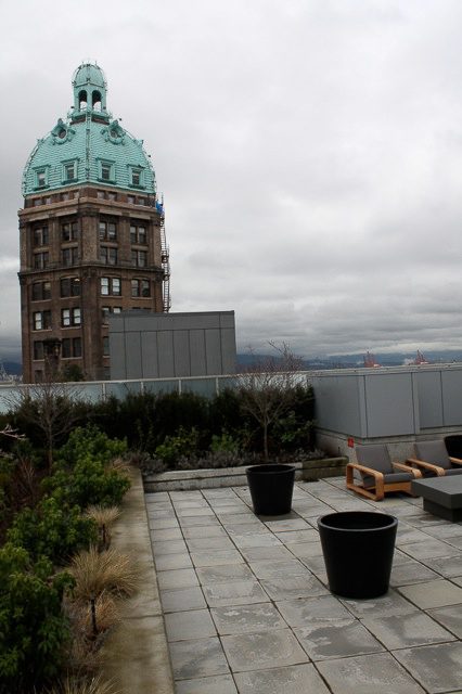 Penthouse with rooftop garden, city view, and historic tower backdrop. - 702- 546 Beatty Street, Vancouver Downtown