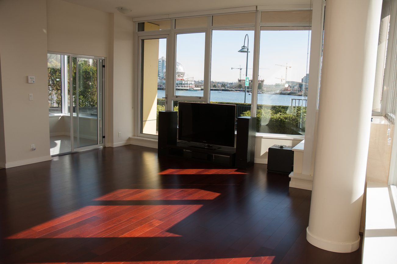 Bright living room with hardwood floors and a city view. - 100-9 Smithe Mews, Vancouver Downtown